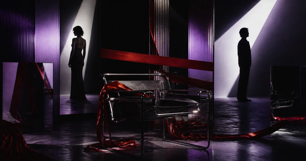 An original neon-lit illustration of two silhouettes divided by a glamorous mirrored studio